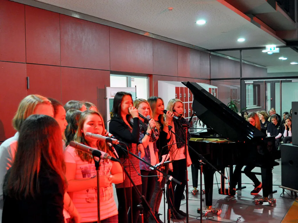 Chor singt am Flügel im Foyer.